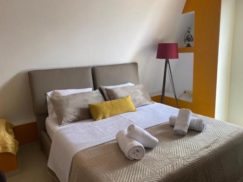 a bedroom with a bed with towels on it at Your Apartment in Pogradec