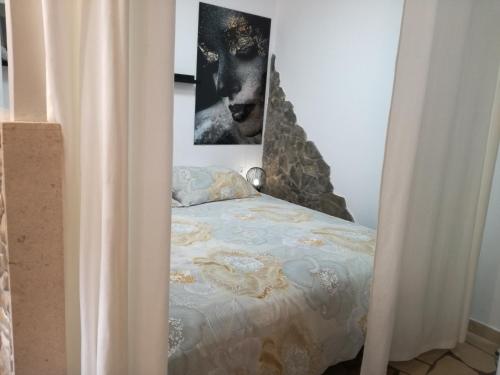 a bedroom with a bed with a picture on the wall at Relax tiny villas 40 meters of the beach in Korčula