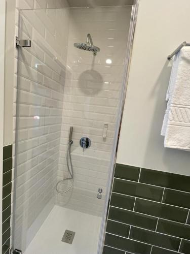 a bathroom with a shower with a glass door at Centro da Vila in Ponte de Lima