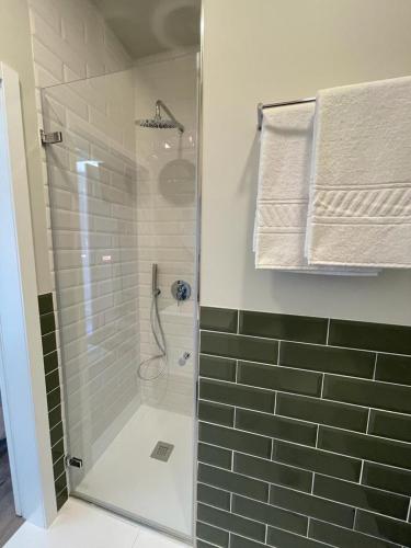 a bathroom with a shower with a glass door at Centro da Vila in Ponte de Lima