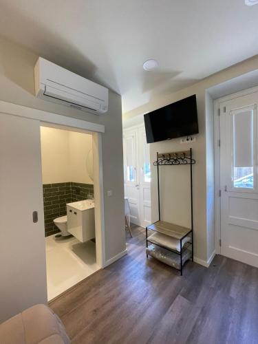 a room with a bathroom with a sink and a mirror at Centro da Vila in Ponte de Lima
