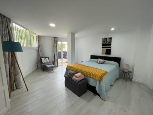 a bedroom with a bed with a yellow blanket at Wave watch terrace apartment in Benalmádena