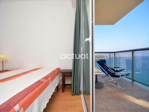 a bedroom with a bed and a desk and a chair at President B-14 in Platja d'Aro