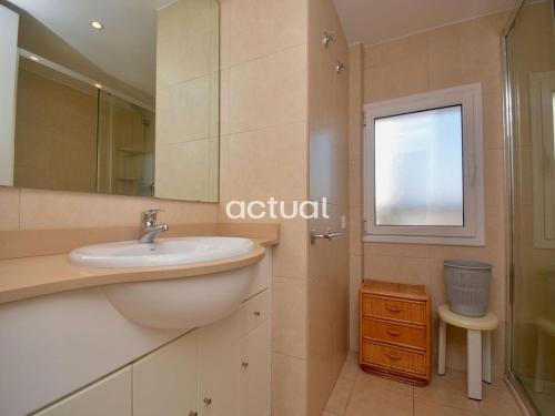 a bathroom with a sink and a shower and a window at President B-14 in Platja d'Aro