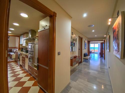 a kitchen with a checkered floor at Luxury beachfront, free private parking in Fuengirola