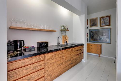 a kitchen with a wooden counter top in a room at Downtown Apartments Riverside & Parking Szafarnia Street in Gdańsk