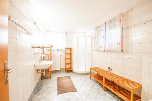 a bathroom with a sink and a toilet and a bench at Ferienhaus Ennsling in Haus im Ennstal