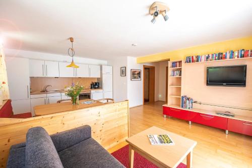a living room with a couch and a table at Ferienhaus Ennsling in Haus im Ennstal