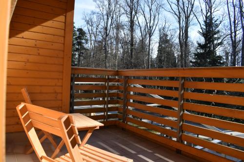 a wooden porch with a wooden bench on a deck at Aparthotel Snjezna Kraljica in Zagreb