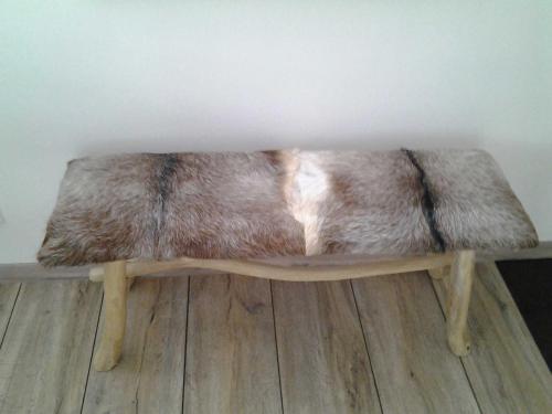 a faux fur bench sitting on top of a wooden floor at Malerwinkel & Tuchereck in Michelstadt