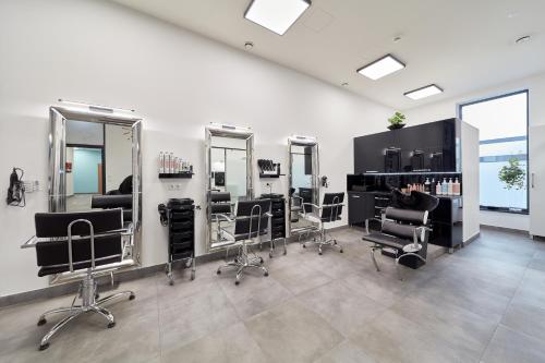 a salon with mirrors and chairs in a room at ibis Styles Nowy Targ in Nowy Targ