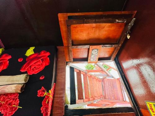 a painting of a window in a wooden box with roses at Dragon Pearl Beach Resort in Kota Belud