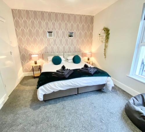 a bedroom with a bed with two blue balls on it at Comfortable Home in Hull in Hull