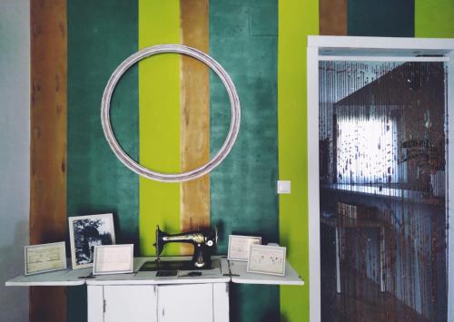 a room with a mirror on a green wall at Albergue Casa Vacas in Carriazo