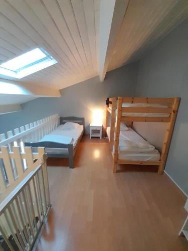 Cette chambre comprend 2 lits superposés et une lucarne. dans l'établissement Appartement SOULAC SUR MER À 500 m de la plage N 4, à Soulac-sur-Mer