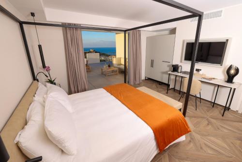 a bedroom with a large bed with a view of the ocean at Maria Die in Calvi