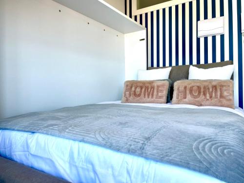 um quarto com uma cama com duas almofadas em Estudio impresionantes vistas con terraza y piscina em Baiona