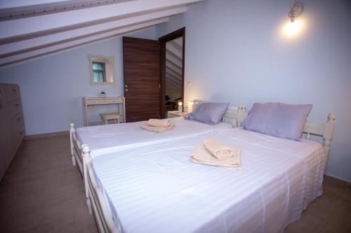 a large white bed with towels on top of it at Casa di Castellano in Corfu