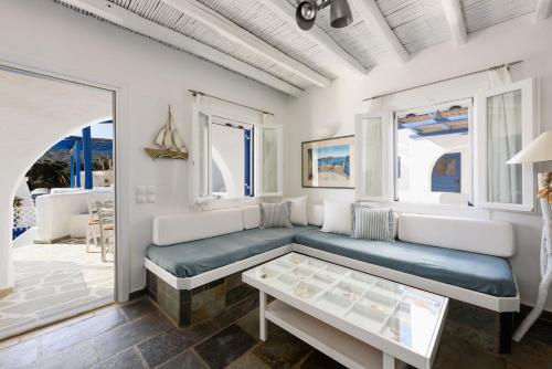 a living room with a couch and a table at Paros 3 bedrooms Messonette for 6 persons by MPS in Kampos Paros