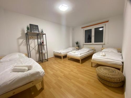 a room with three beds and a window at Sali - E4 - WLAN, Waschmaschine in Essen