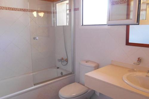 a bathroom with a toilet and a shower and a sink at Casa con impresionantes vistas al mar in Tossa de Mar