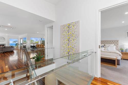 a glass staircase leading to a living room with a couch at Luxurious Terrace Hideaway with a Heated Pool in Ocean Grove