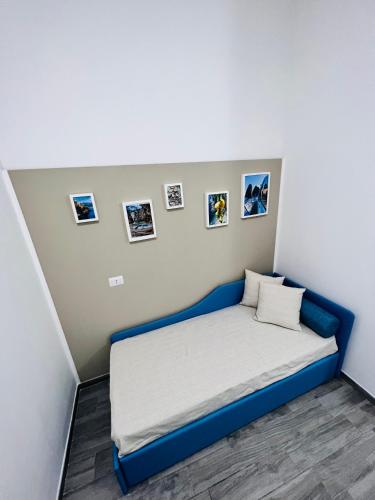 a bed in a room with pictures on the wall at B&B BenInCasa in Vietri sul Mare