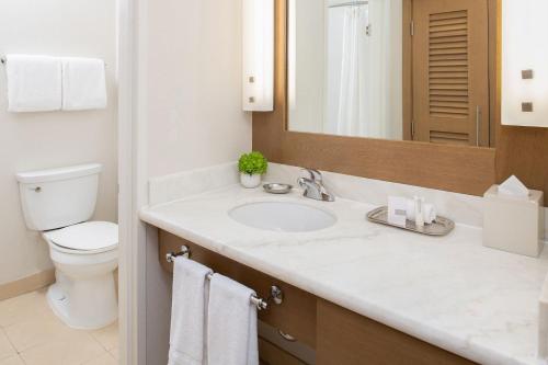 a bathroom with a sink and a toilet and a mirror at The Lodge at Tiburon in Tiburon