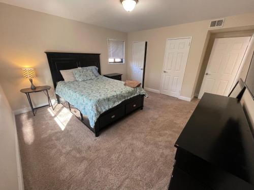 a bedroom with a bed and two white doors at Spacious 2 bedroom in Chevy chase in Chevy Chase