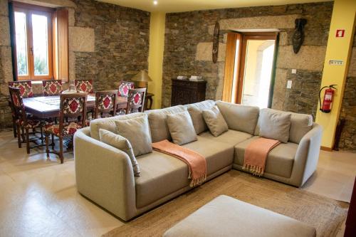 a living room with a couch and a table at Quinta da Eira Douro Valley in Fermentões