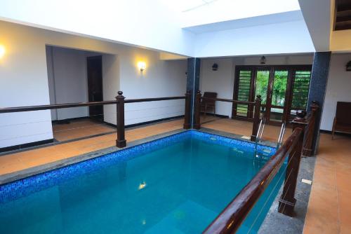 a swimming pool in a house at Heaven Inn Munnar in Munnar