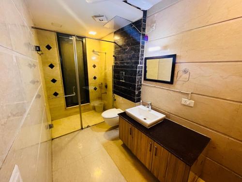 a bathroom with a sink and a toilet at Abode Residency Safdarjung Enclave Near U S Embassy Delhi in New Delhi