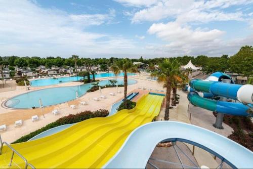 维亚斯Mobilhome Vias plage dans Camping的一个带游泳池的水上公园的滑梯