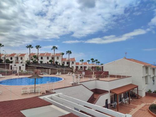 a view of the pool at a resort with palm trees at Sunshine Villas Canarias in Adeje
