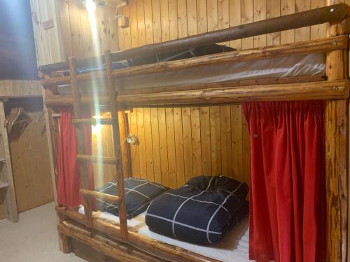 a bunk bed with two pillows in a room at Le p'tit coin montagne 2 in Bonneval-sur-Arc