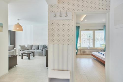 un soggiorno con divano e un letto in una camera di Apartament w Paski - z tarasem - Playa Baltis a Międzyzdroje