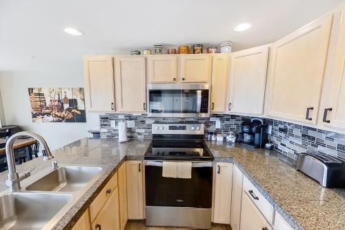 a kitchen with a sink and a stove top oven at Park Pointe Lakeside Retreat A101 in Chelan