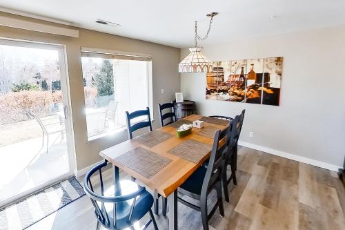 a dining room with a wooden table and chairs at Park Pointe Lakeside Retreat A101 in Chelan