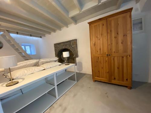 a room with a bed and a wooden cabinet at Little Blue in Chorio, Symi in Symi