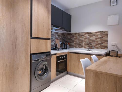a kitchen with a washer and dryer in it at Forest View Apartments in Kololi