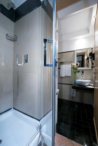 a bathroom with a shower and a sink at Duca d'Alba Hotel - Chateaux & Hotels Collection in Rome