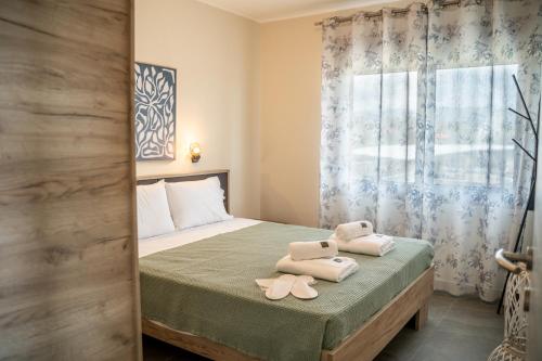a bedroom with a bed with two towels on it at Villa Eva Dikella in Mesimvría