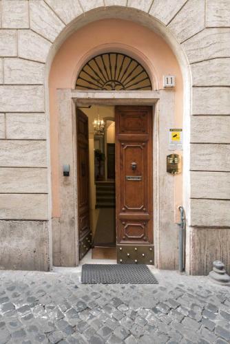 an entrance to a building with a wooden door at Duca d'Alba Hotel - Chateaux & Hotels Collection in Rome