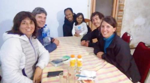 a group of people sitting around a table at Pak Tasrip Homestay in Bromo