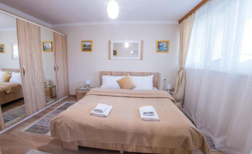 a bedroom with a bed with two towels on it at Casa-Naro in Mostar
