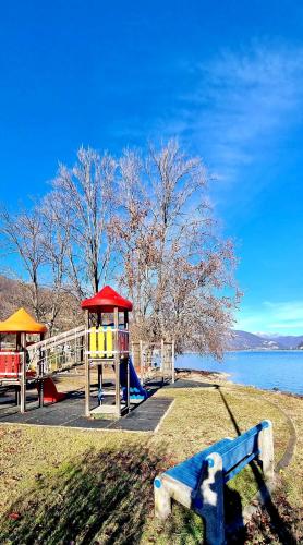 a park with a playground and a play structure at ZARA HOUSE - Lake and Pet Friendly in Brusimpiano