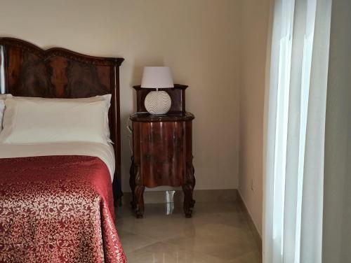 a bedroom with a bed and a lamp on a table at Ca' Mazzega in Murano