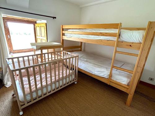 two bunk beds in a room with a window at Cottage de Keran in Arradon