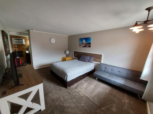 a bedroom with a bed and a couch in it at Country Inn of Shelby in Avoca