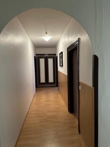 an empty hallway with a hallway leading to a door at Hotel-Café-Burg Stahleck in Bacharach